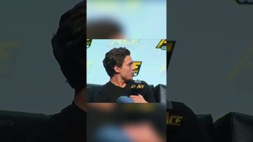 Person speaking at a convention panel discussion.