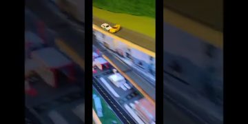 Toy cars racing on miniature track.