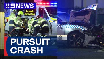 Emergency services respond to police car crash scene.