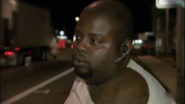 Person wearing headset on a night street