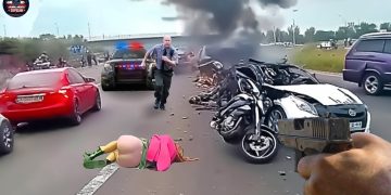 Car crash scene with police and burning wreckage.