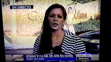 Reporter on TV, discussing ATM robbery news.