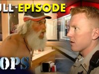 Police officer talking to man inside restaurant