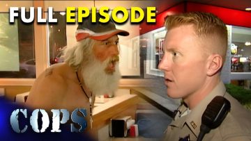 Police officer talking to man inside restaurant