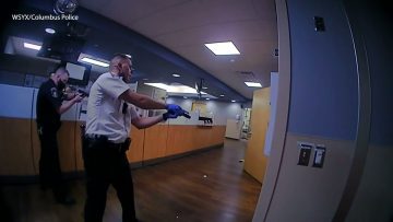 Police officers in a hospital corridor.