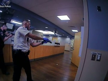 Police officers in a hospital corridor.