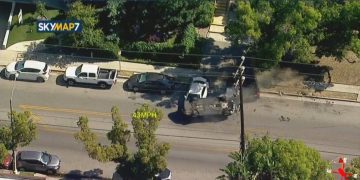 Aerial view of a police car chase on street.