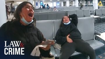 People sitting in airport waiting area, wearing masks.
