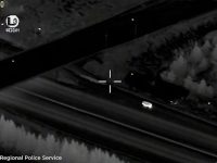 Nighttime aerial view, vehicle moving on road