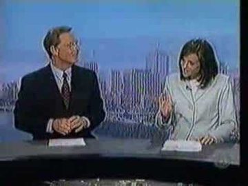 News anchors discussing at studio desk.