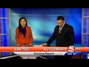 News anchors on live broadcast set.
