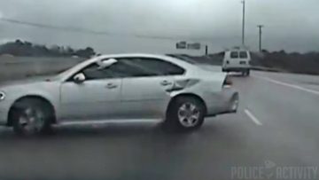 Car involved in highway accident, damaged side.