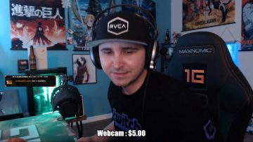 Gamer streaming with headset and posters behind.