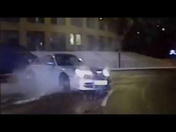 Car drifting on wet road at night