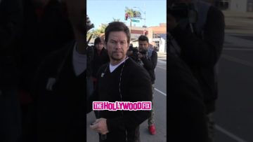 Person caught by paparazzi on city street.