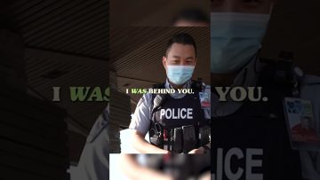 Masked police officer in uniform, wearing body armor.