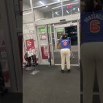 Person pushing shopping cart near store exit