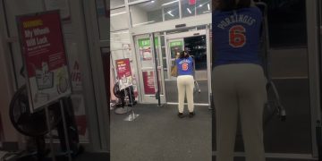 Person pushing shopping cart near store exit
