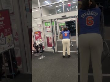 Person pushing shopping cart near store exit