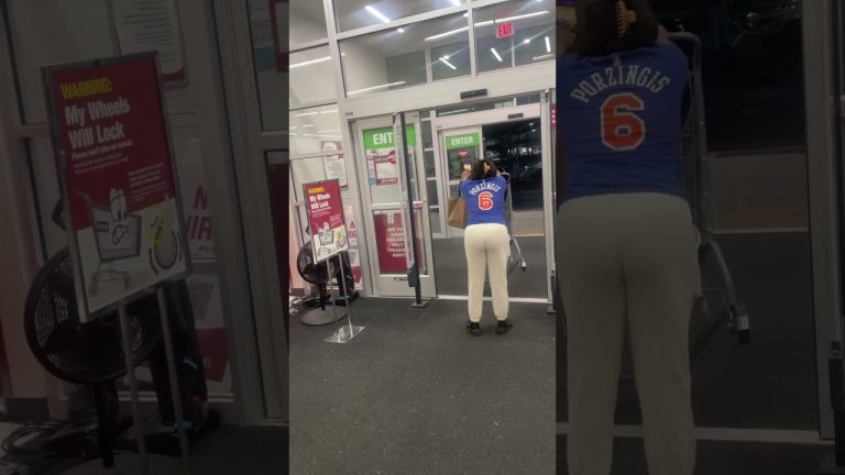 Person pushing shopping cart near store exit