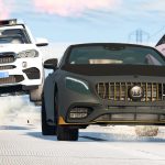 Cars racing on snowy road with police chase