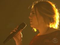 Singer performing on stage with microphone