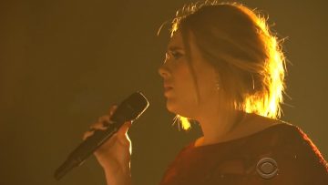 Singer performing on stage with microphone
