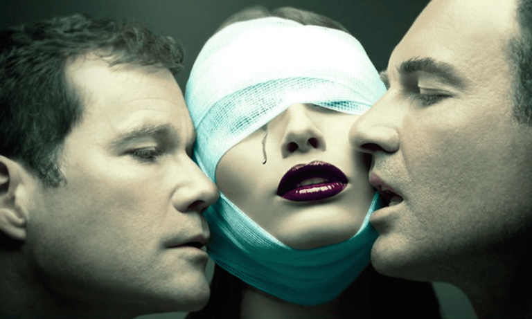 Woman with bandaged eyes flanked by two men.