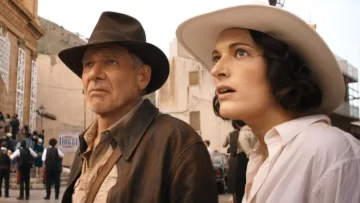 Two people in vintage clothing outdoors.