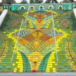 Colorful mosaic staircase with vibrant floral designs.