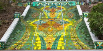 Colorful mosaic staircase with vibrant floral designs.