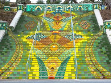 Colorful mosaic staircase with vibrant floral designs.
