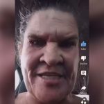 Close-up of a person in a car using app interface.