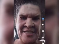 Close-up of a person in a car using app interface.