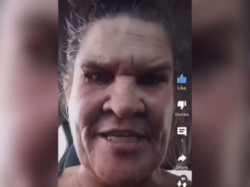 Close-up of a person in a car using app interface.