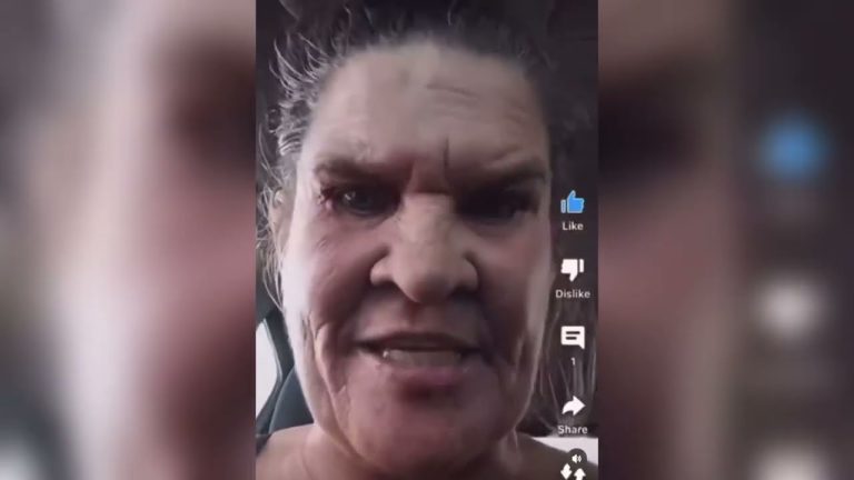 Close-up of a person in a car using app interface.