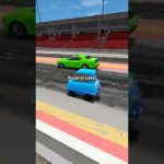 Blue car racing past green car on track.
