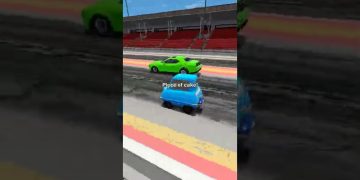 Blue car racing past green car on track.