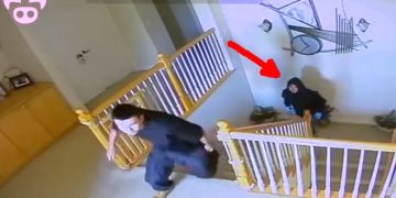 Security footage of figures on staircase, arrow pointing.