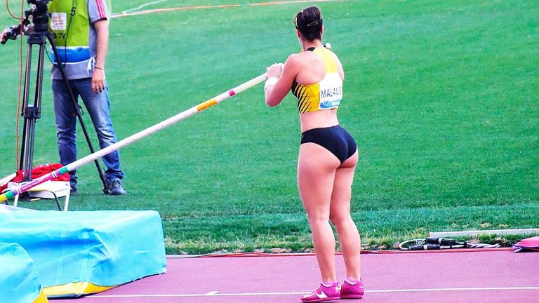Athlete prepares for pole vault competition.