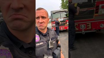 Police and firefighters near truck outdoors.