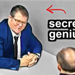 Man in suit labeled secret genius at table
