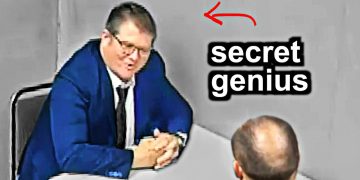 Man in suit labeled secret genius at table