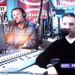 Radio hosts speaking live on air with microphones.