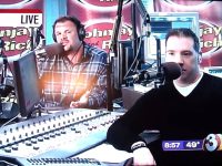 Radio hosts speaking live on air with microphones.