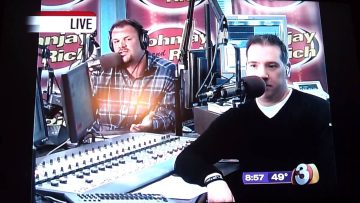 Radio hosts speaking live on air with microphones.