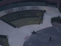 Helicopter view of building entrance and landscaping
