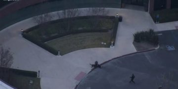 Helicopter view of building entrance and landscaping