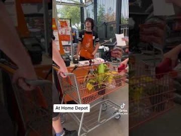 Person with cart at a Home Depot store.
