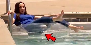 Woman on pool float with red arrow